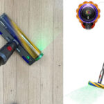 Dyson V15 Detect vacuum cleaning hardwood floors with green laser light revealing microscopic dust particles